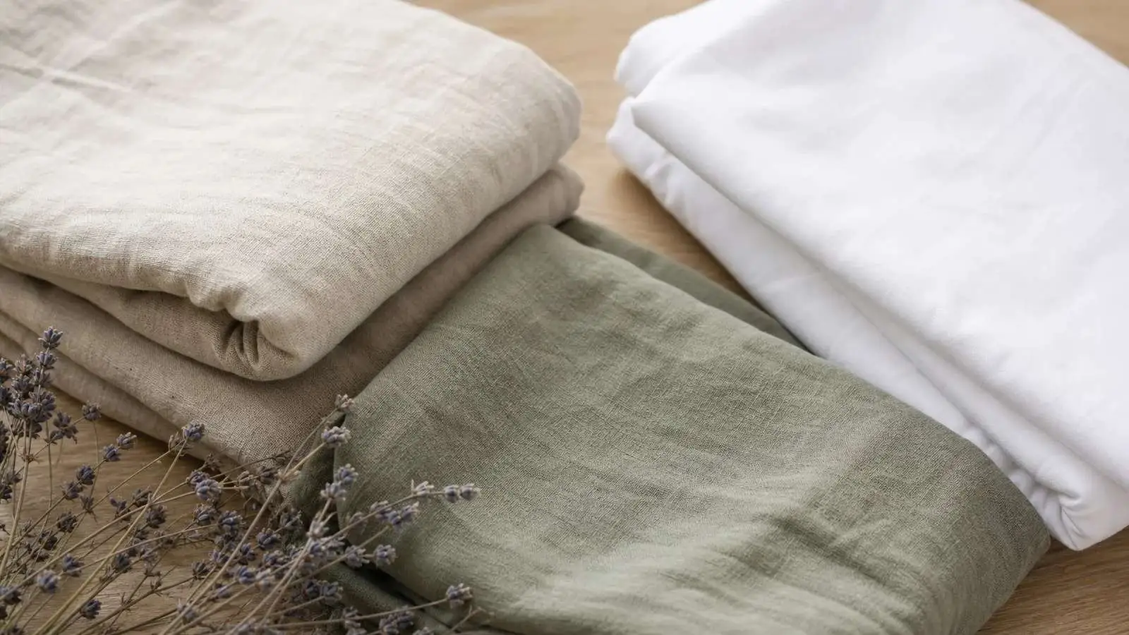 Folded natural linen and organic cotton sheets — non-toxic bedding