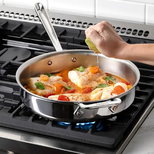 Healthy food searing in a stainless steel pan on a modern stovetop