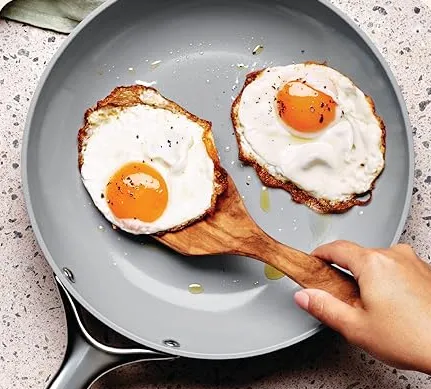 PFAS-free ceramic frying pan cooking eggs on a modern stovetop — non-toxic kitchen essentials